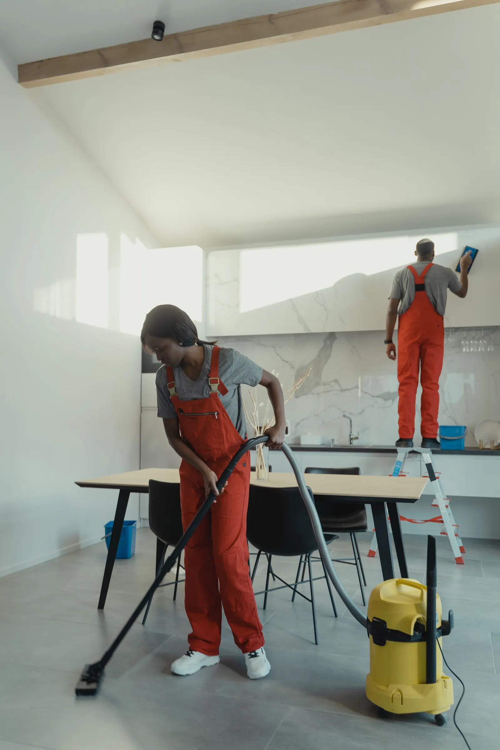 Professional cleaning team working inside a home