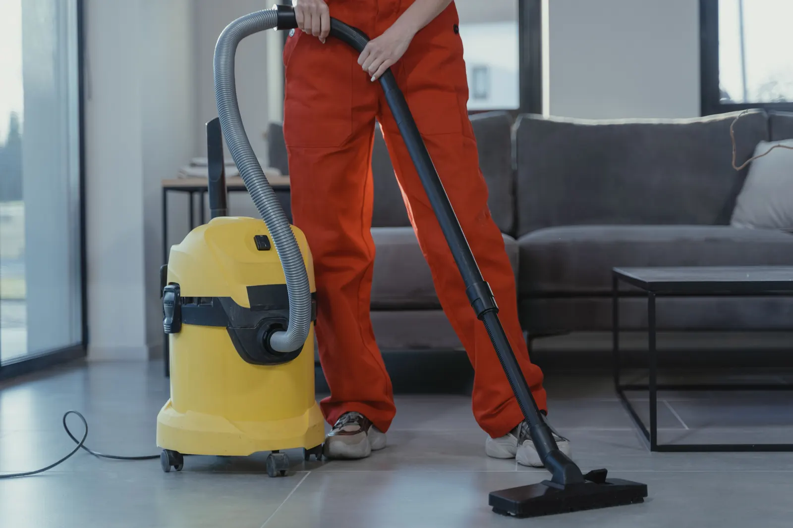 Professional floor vacuuming in a living room