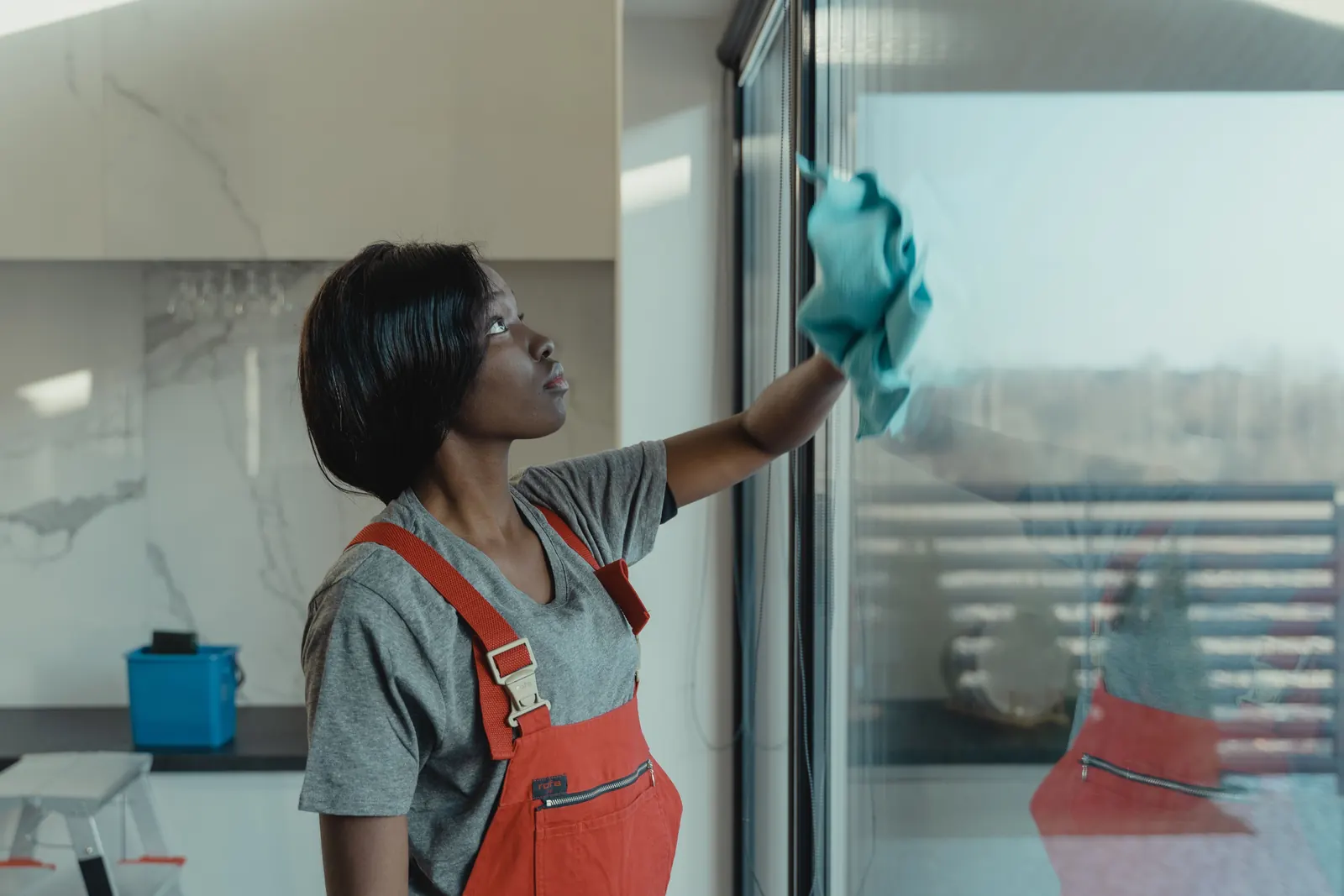 Cleaner wiping a large glass window