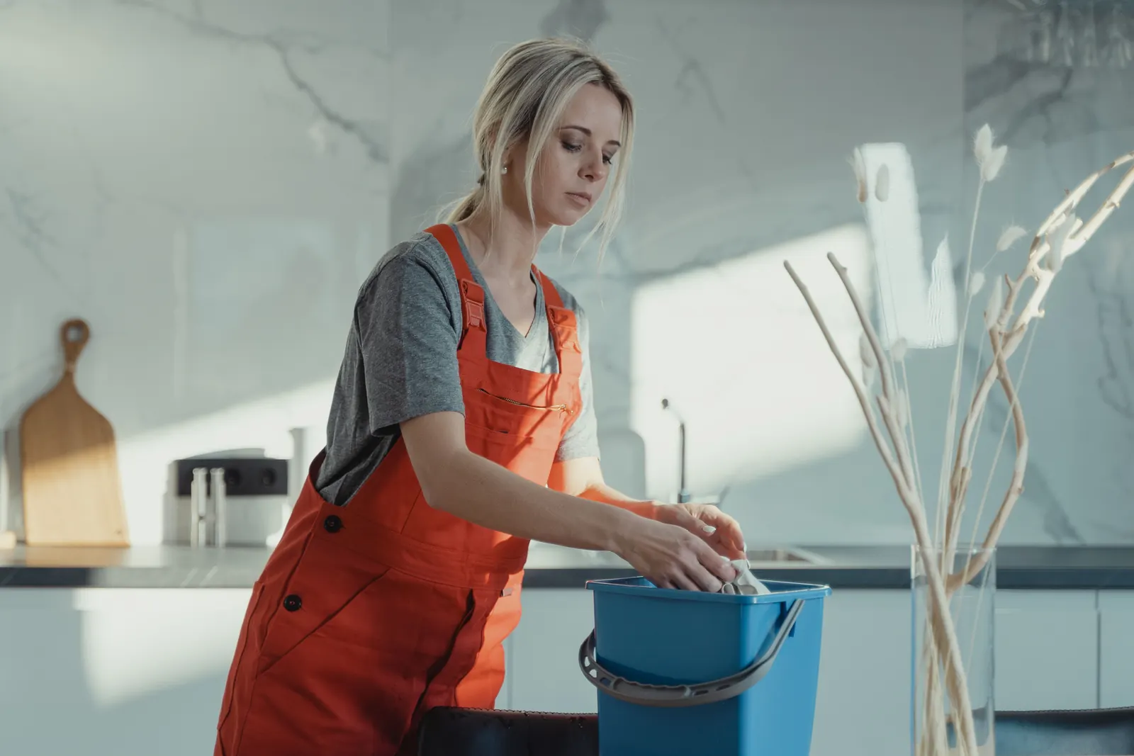 Professional cleaner preparing to deep clean a modern kitchen