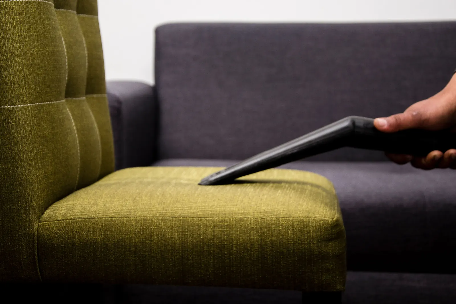 Vacuum nozzle cleaning upholstered sofa fabric